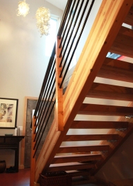 Engineer lumber (glulam beams) used for a cost effective open stair design.