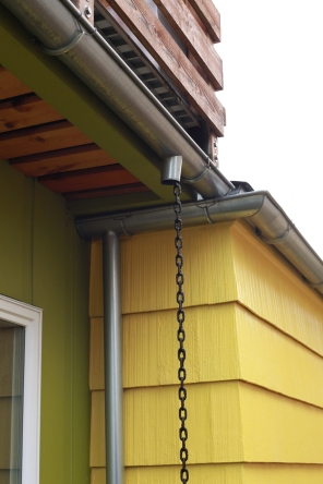 New meets old, with galvanized half round gutters and rain chain.